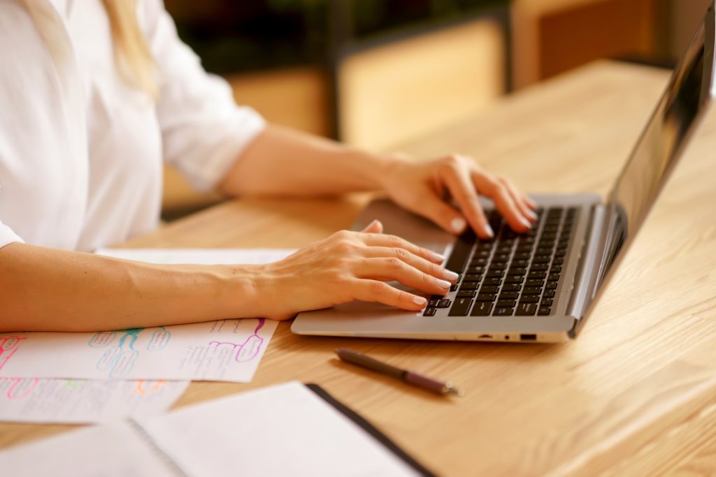 a job applicant woman working on her laptop to create a job portfolioÂ 