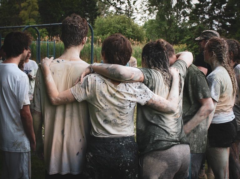 a group of people discussing teamwork factors during a team building activity