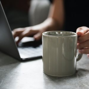 a certified professional resume writer holding a cup of coffee