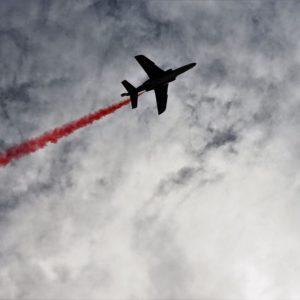 A worm's eye view of an airplane with a red streak similar to showing top skills in your resume