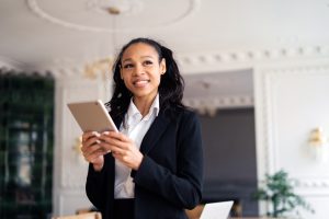 a woman holding tablet dress formal for online job interview