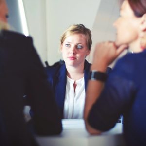 Female applicant showing bad job interview antics in front of two female interviewers