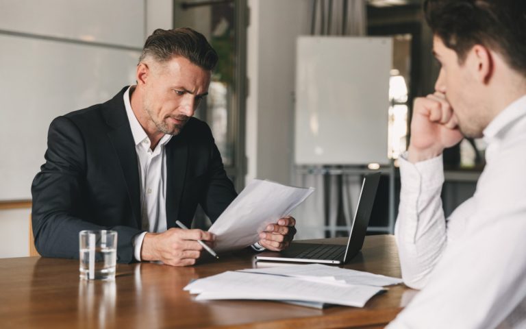 an HR manager reading a resume during an interview