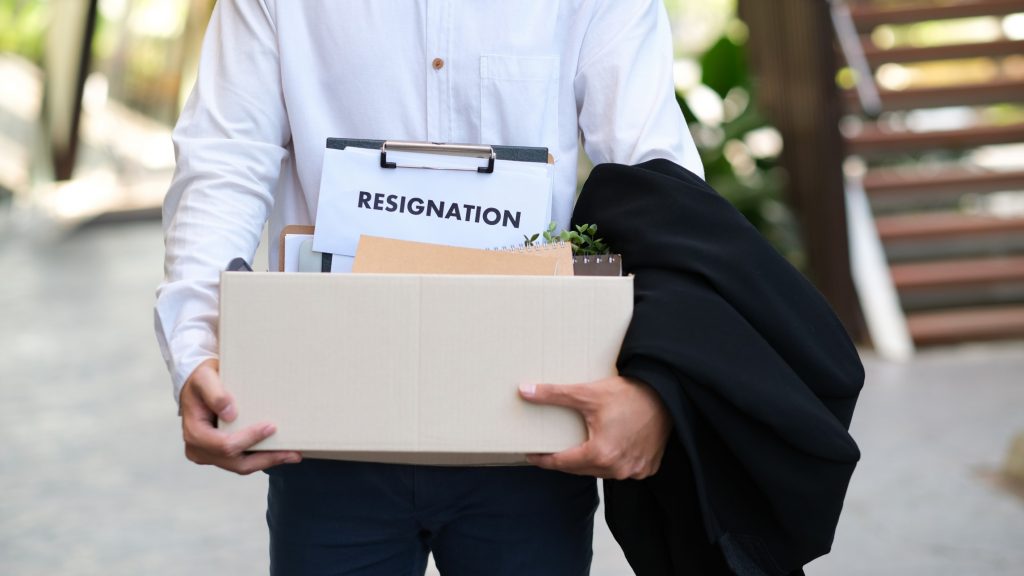 employee carrying his belongings after resigning