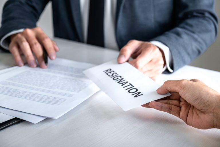 employee handing over his resignation letter to employer