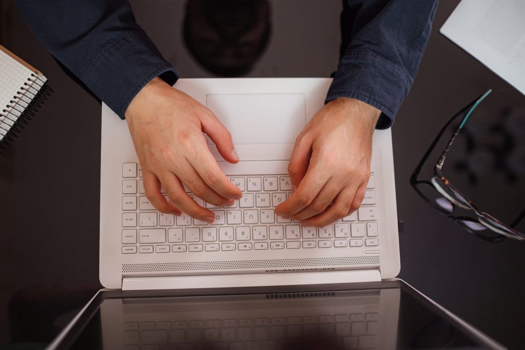 employee typing his resignation letter on his laptop