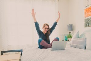 a happy positive woman raising her hands