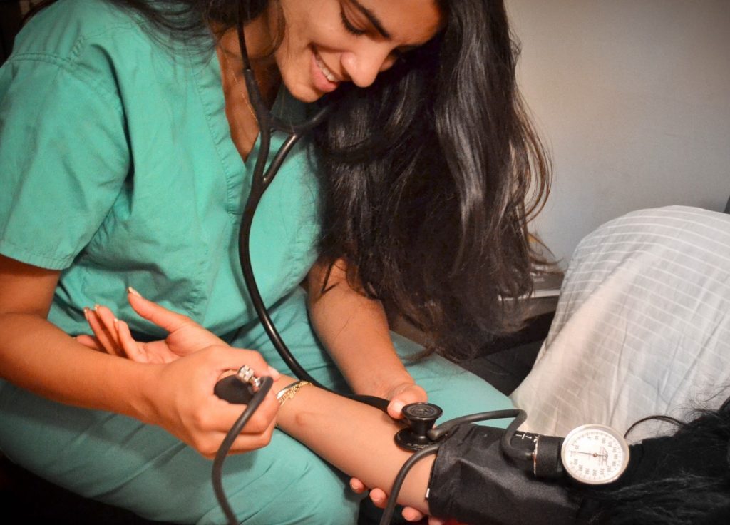 healthcare worker examining a patient