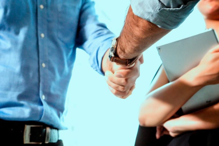 man shakes hand of colleague for the new job