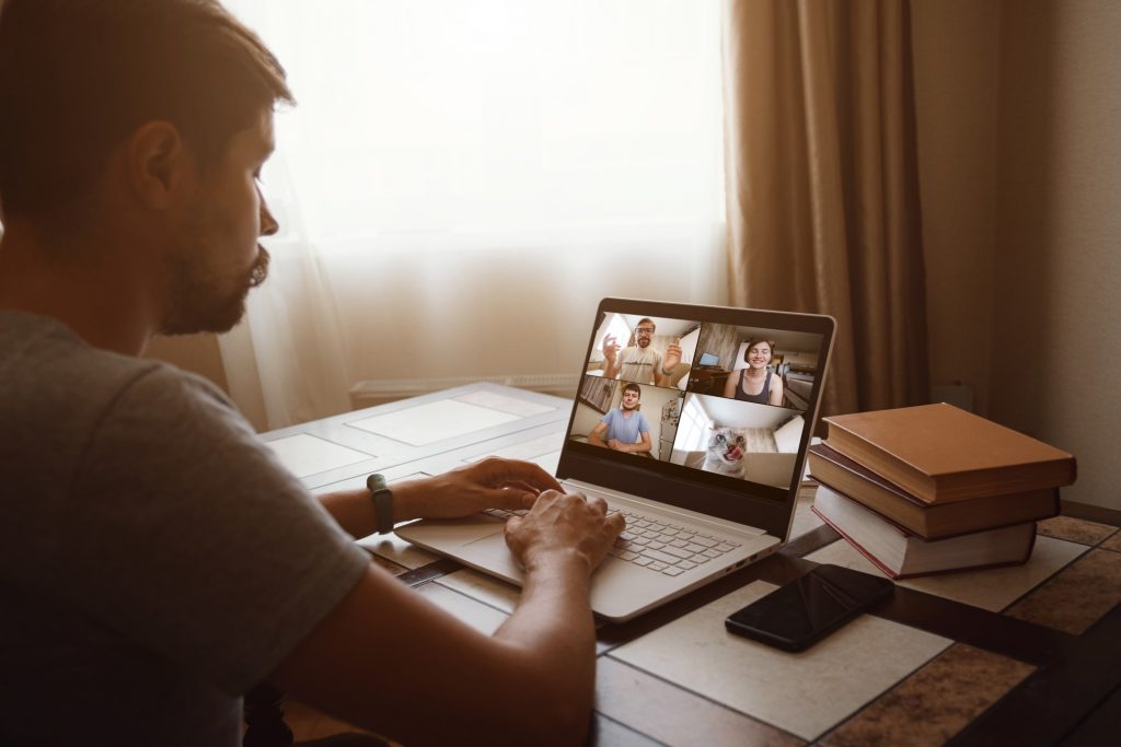 man talking to his team online via zoom meeting