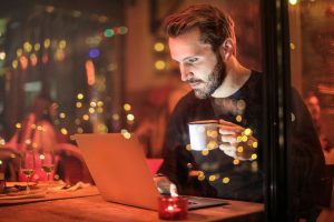 Man working on a holiday with workaholic signs