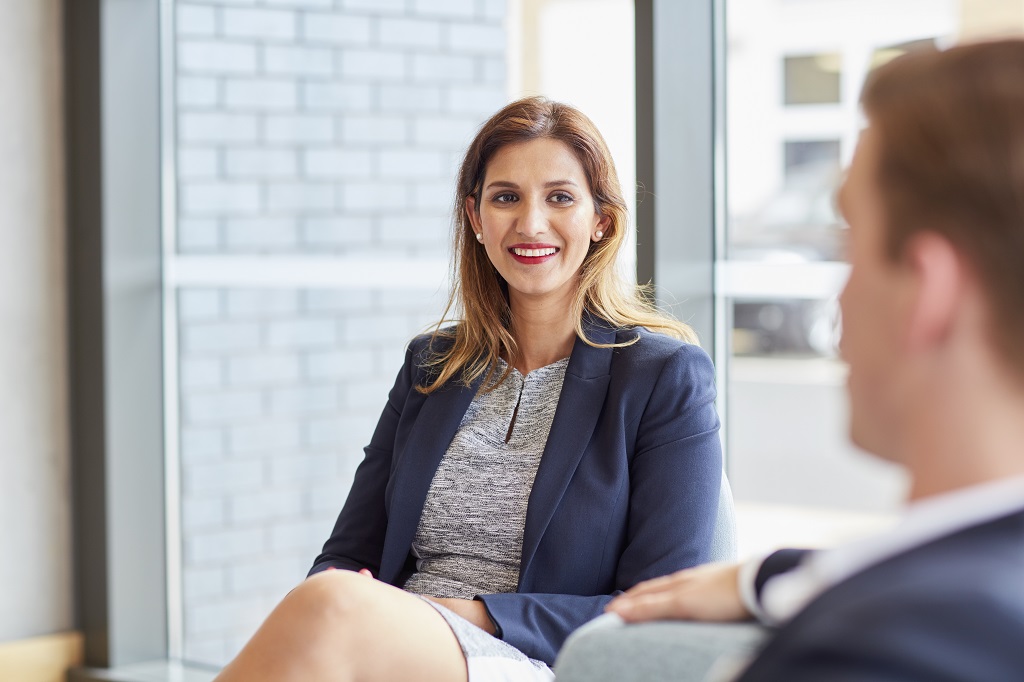 A woman listening to advisor about workplace etiquette