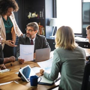 People inside a conference room discussing a resume that catch employers' attention