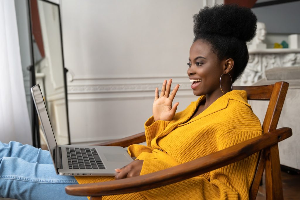 smiling woman engaging in online meeting with colleagues