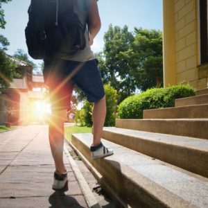 Man climbing stairs like pursuing a dream job