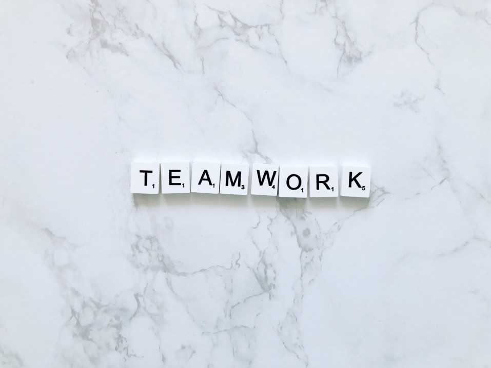 teamwork spelled using scrabble pieces