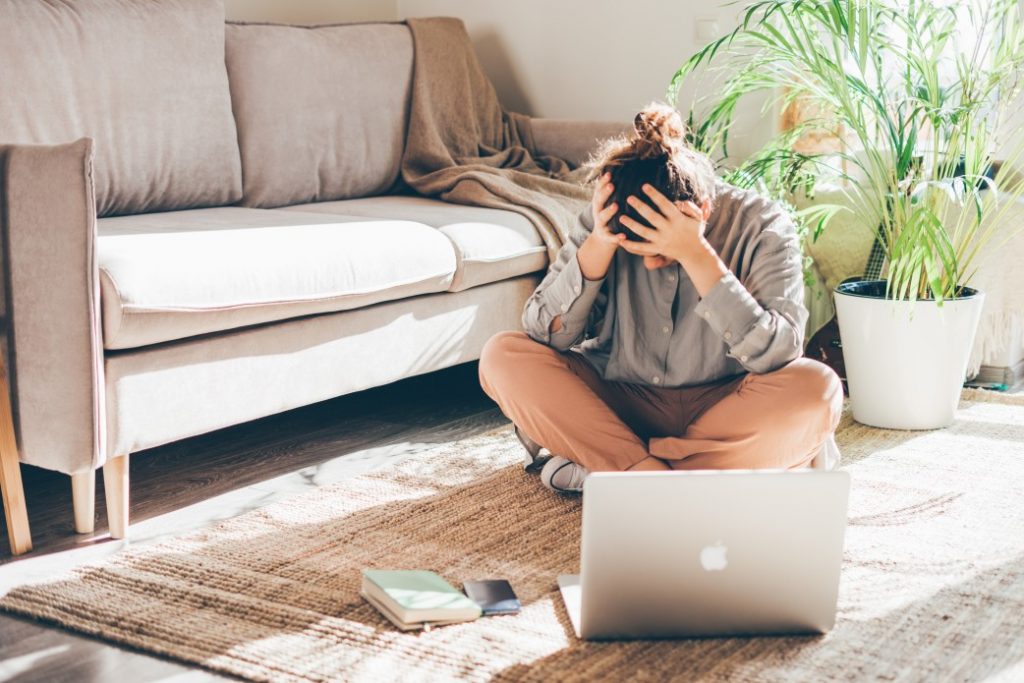 a woman in despair looking for other jobs after losing her job