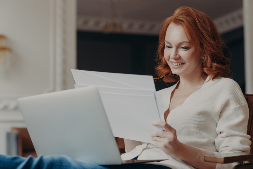 woman reviewing her printed resume