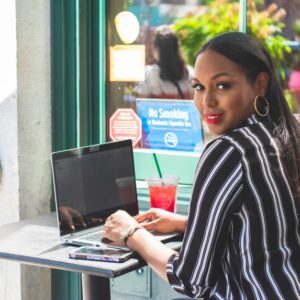 Woman writing a cover letter outside a cafe